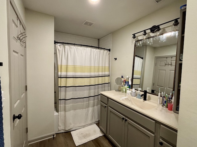 11630 N Varnon School Rd, Hallsville, MO 65255 - full bathroom featuring wood finished floors, vanity, and shower / bathtub combination with curtain