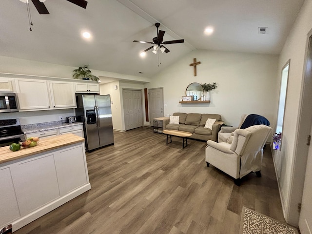 11630 N Varnon School Rd, Hallsville, MO 65255 - living room featuring a ceiling fan, lofted ceiling, wood finished floors, and baseboards