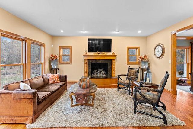 70 E High Point Ln, Columbia, MO 65203 - living room featuring a fireplace with raised hearth, wood finished floors, baseboards, and recessed lighting