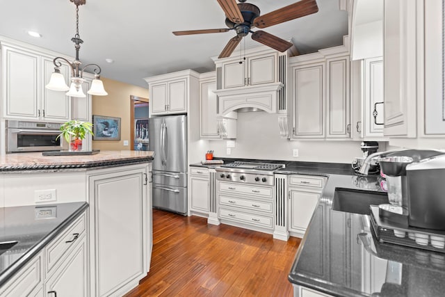 70 E High Point Ln, Columbia, MO 65203 - kitchen with appliances with stainless steel finishes, a ceiling fan, dark wood-type flooring, a sink, and decorative light fixtures