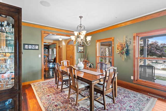 70 E High Point Ln, Columbia, MO 65203 - dining space with a chandelier, ornamental molding, baseboards, and wood finished floors