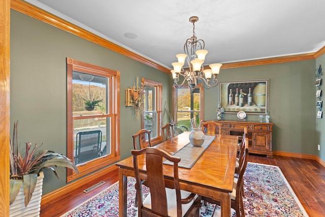 70 E High Point Ln, Columbia, MO 65203 - dining space featuring a chandelier, healthy amount of natural light, crown molding, hardwood / wood-style floors, and baseboards