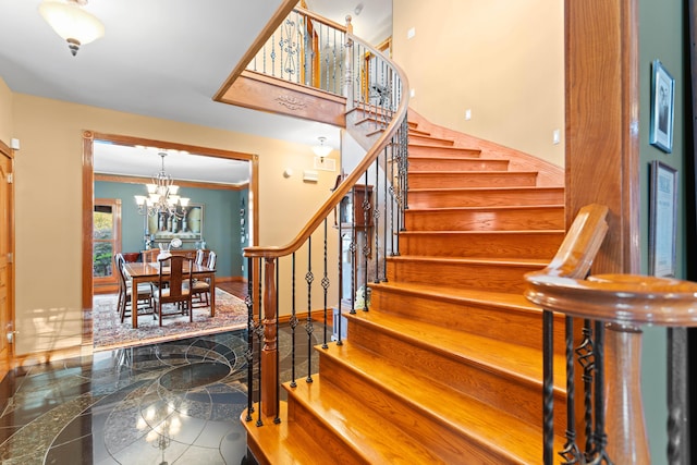 70 E High Point Ln, Columbia, MO 65203 - staircase with a chandelier, baseboards, and ornamental molding
