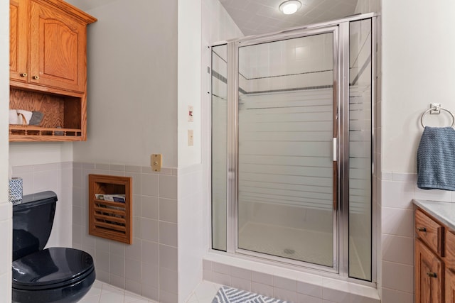 70 E High Point Ln, Columbia, MO 65203 - bathroom with tile walls, a shower stall, toilet, vanity, and a wainscoted wall