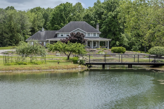 70 E High Point Ln, Columbia, MO 65203 - rear view of house with a water view, a chimney, a porch, and a wooded view