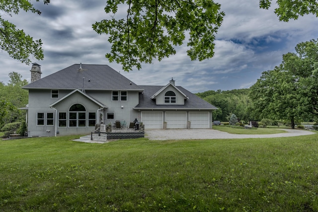 70 E High Point Ln, Columbia, MO 65203 - rear view of property featuring driveway, a chimney, a lawn, and stucco siding