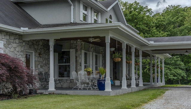 70 E High Point Ln, Columbia, MO 65203 - view of home's exterior with stone siding, a shingled roof, covered porch, and a ceiling fan