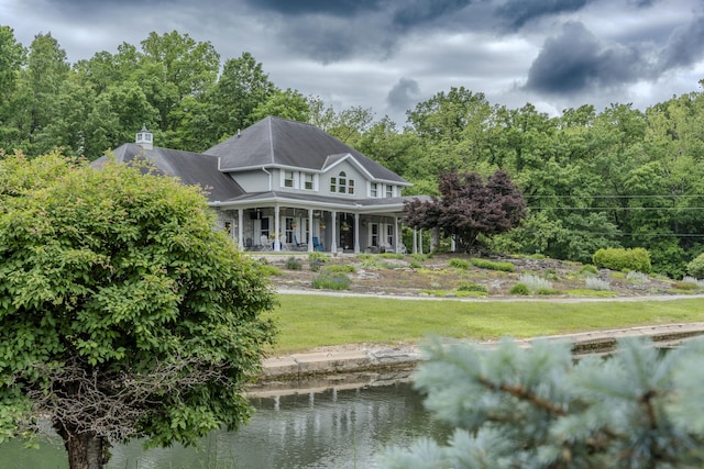 70 E High Point Ln, Columbia, MO 65203 - rear view of house featuring a lawn, covered porch, and a water view