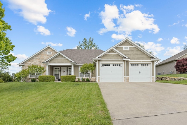 1703 Ballentine Ln, Columbia, MO 65201 - craftsman-style house featuring stone siding, concrete driveway, a front yard, and an attached garage