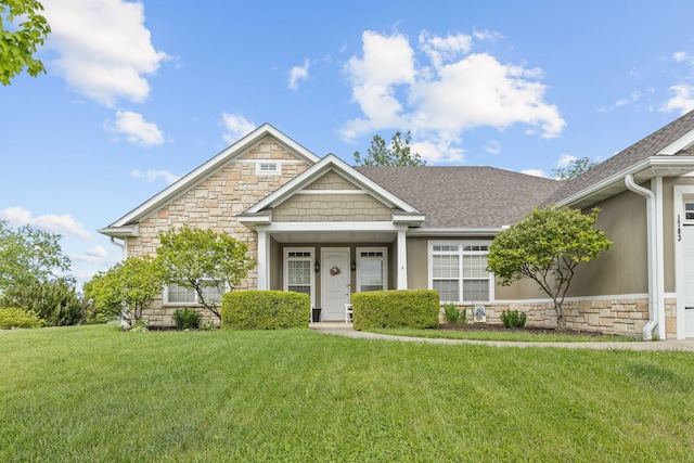 1703 Ballentine Ln, Columbia, MO 65201 - view of front of property with stone siding, a front yard, and roof with shingles