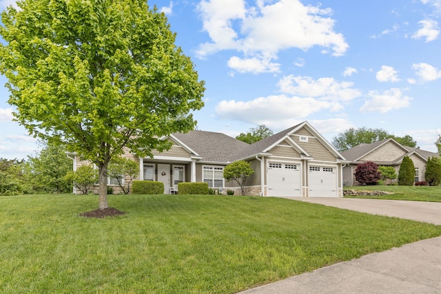 1703 Ballentine Ln, Columbia, MO 65201 - view of front of home with an attached garage, a front yard, concrete driveway, and stone siding