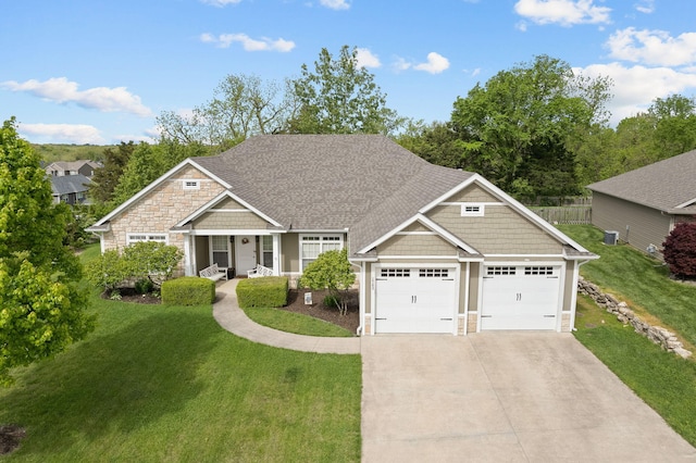 1703 Ballentine Ln, Columbia, MO 65201 - craftsman-style house with stone siding, concrete driveway, a garage, a porch, and central AC