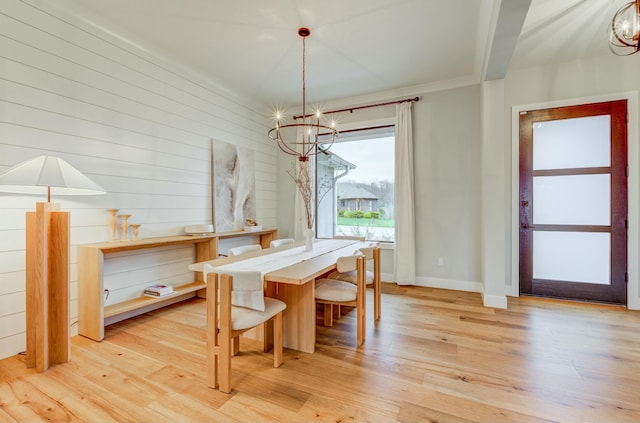 214 Hellwig Ln, Columbia, MO 65203 - dining area with a chandelier, light wood finished floors, and baseboards