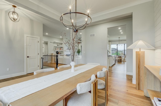 214 Hellwig Ln, Columbia, MO 65203 - dining room with a chandelier, light wood finished floors, recessed lighting, ornamental molding, and baseboards