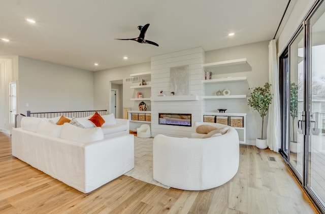 214 Hellwig Ln, Columbia, MO 65203 - living room featuring wood finished floors, a fireplace, ceiling fan, recessed lighting, and baseboards