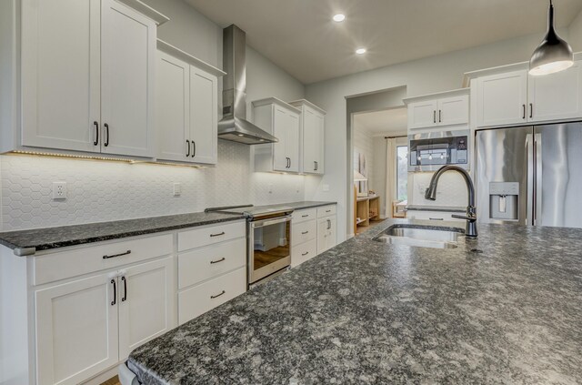 214 Hellwig Ln, Columbia, MO 65203 - kitchen with appliances with stainless steel finishes, wall chimney exhaust hood, a sink, tasteful backsplash, and white cabinets