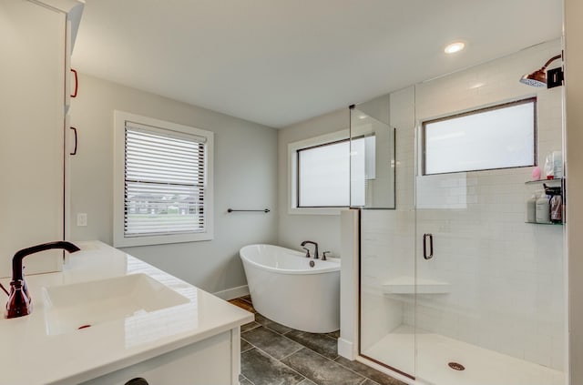 214 Hellwig Ln, Columbia, MO 65203 - bathroom featuring vanity, a shower stall, a freestanding tub, recessed lighting, and baseboards