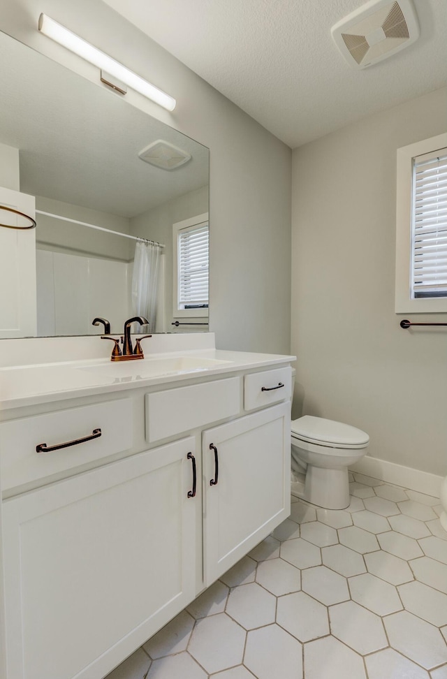 214 Hellwig Ln, Columbia, MO 65203 - bathroom with toilet, vanity, tile patterned floors, a shower with curtain, and baseboards