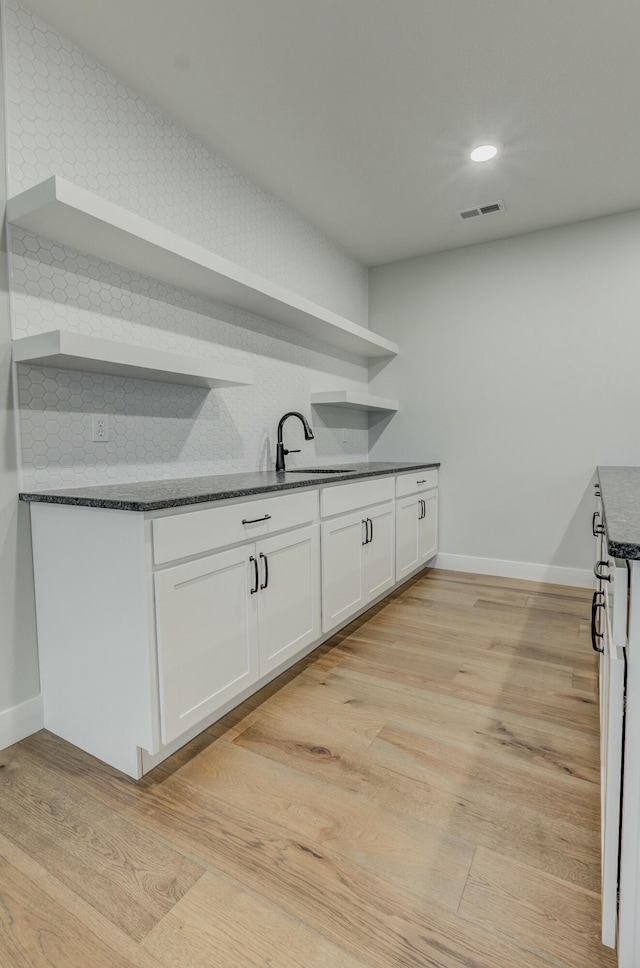 214 Hellwig Ln, Columbia, MO 65203 - kitchen with open shelves, a sink, white cabinetry, light wood finished floors, and baseboards