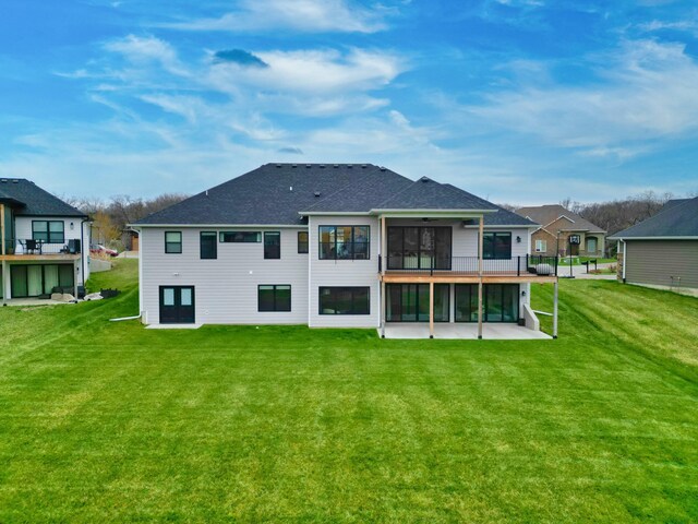 214 Hellwig Ln, Columbia, MO 65203 - back of house with a sunroom, a lawn, and a shingled roof