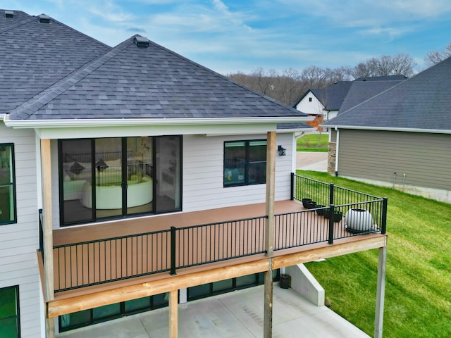 214 Hellwig Ln, Columbia, MO 65203 - rear view of property featuring roof with shingles, a lawn, and a deck