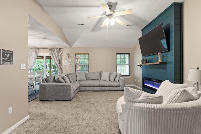 1807 E Phoenix Rd, Columbia, MO 65202 - carpeted living room featuring a fireplace, baseboards, vaulted ceiling, and a ceiling fan
