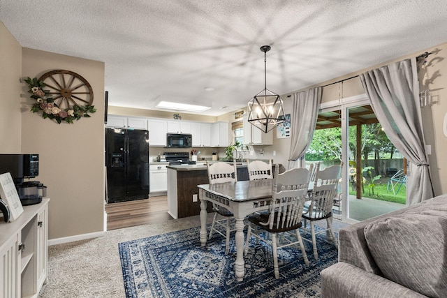 1807 E Phoenix Rd, Columbia, MO 65202 - dining room with a chandelier, a textured ceiling, and baseboards