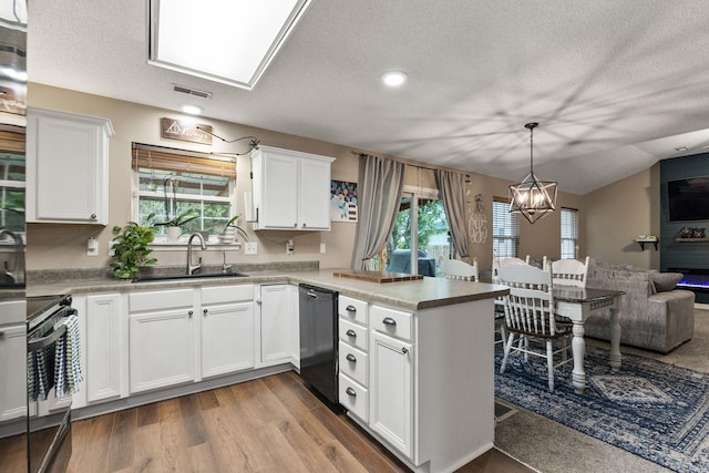 1807 E Phoenix Rd, Columbia, MO 65202 - kitchen featuring dishwashing machine, a sink, a peninsula, stainless steel stove, and a chandelier