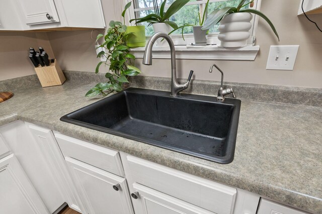 1807 E Phoenix Rd, Columbia, MO 65202 - kitchen view of a sink and white cabinetry