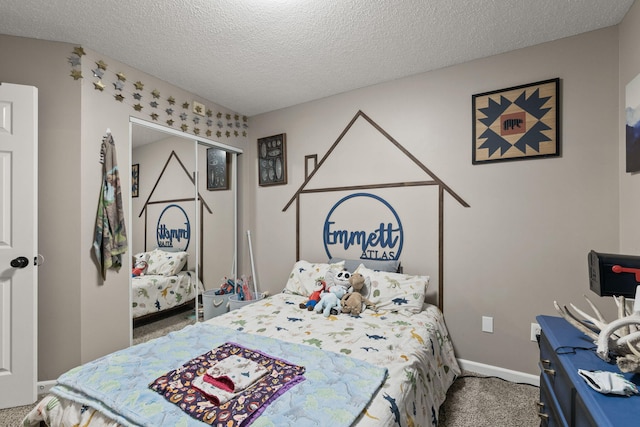 1807 E Phoenix Rd, Columbia, MO 65202 - carpeted bedroom featuring a textured ceiling and baseboards