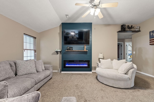 1807 E Phoenix Rd, Columbia, MO 65202 - carpeted living area with baseboards, ceiling fan, a fireplace, and lofted ceiling