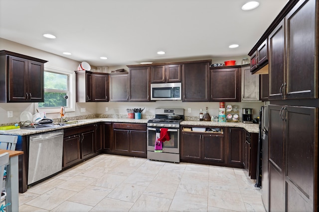 7400 Pemberton Dr, Columbia, MO 65203 - kitchen featuring appliances with stainless steel finishes, a sink, dark brown cabinetry, light stone counters, and recessed lighting