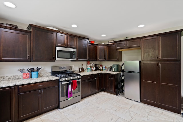 7400 Pemberton Dr, Columbia, MO 65203 - kitchen with appliances with stainless steel finishes, dark brown cabinetry, light stone countertops, and recessed lighting