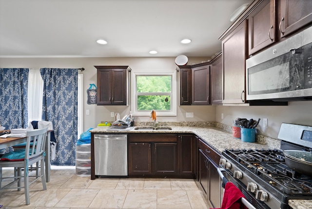7400 Pemberton Dr, Columbia, MO 65203 - kitchen with stainless steel appliances, a sink, dark brown cabinetry, light stone countertops, and recessed lighting