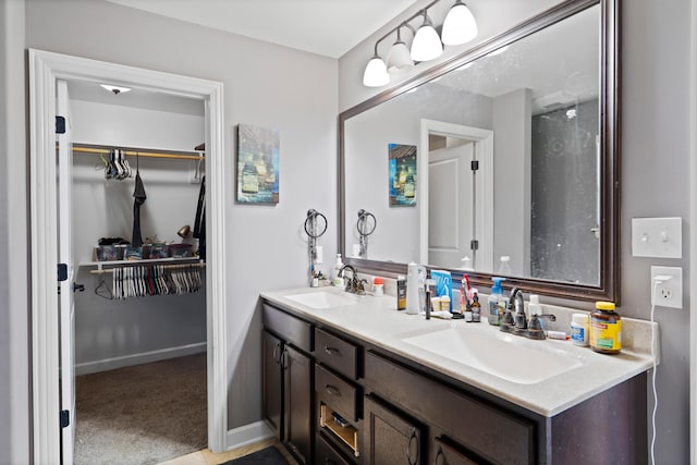 7400 Pemberton Dr, Columbia, MO 65203 - full bath with double vanity, a walk in closet, and baseboards