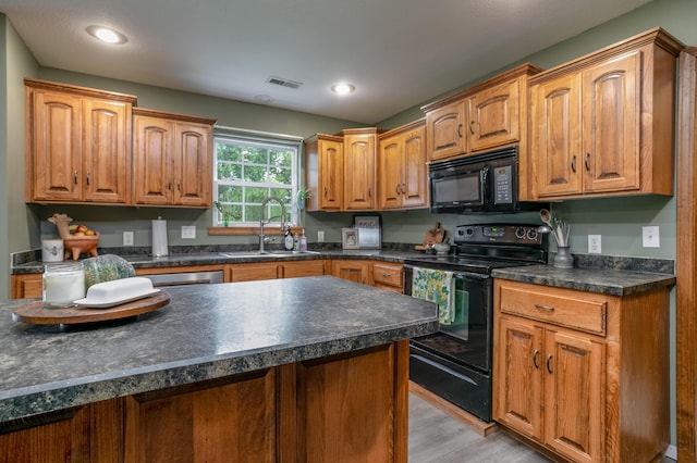 205 Jameson Dr, Ashland, MO 65010 - kitchen with black appliances, a sink, dark countertops, light wood-style floors, and recessed lighting