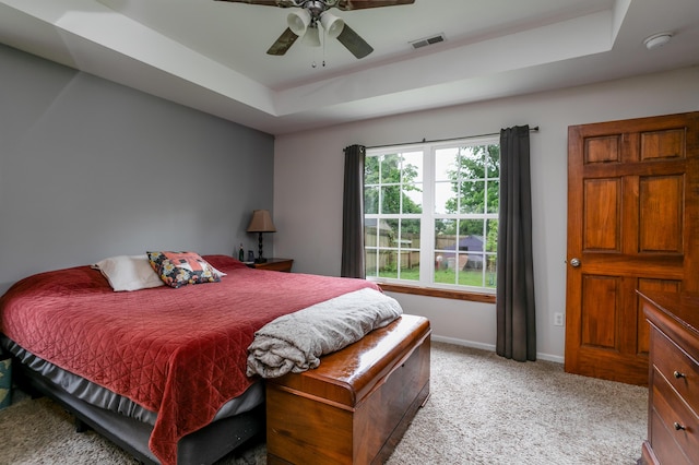 205 Jameson Dr, Ashland, MO 65010 - bedroom featuring a tray ceiling, light carpet, baseboards, and a ceiling fan