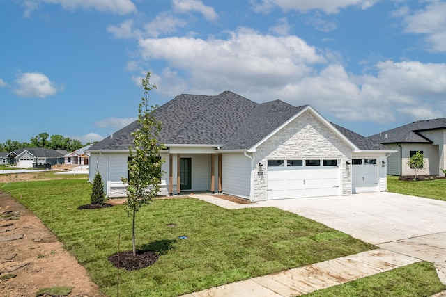 4505 Chambers Bay Dr, Columbia, MO 65201 - view of front of home featuring an attached garage, stone siding, driveway, and a front yard