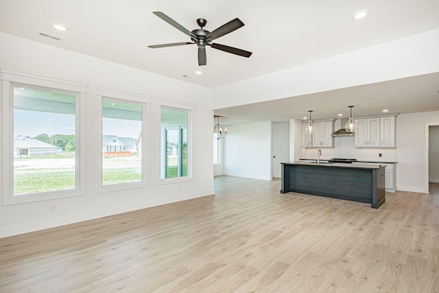 4505 Chambers Bay Dr, Columbia, MO 65201 - unfurnished living room featuring a sink, plenty of natural light, baseboards, light wood-type flooring, and recessed lighting