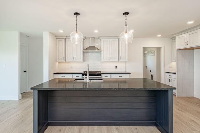 4505 Chambers Bay Dr, Columbia, MO 65201 - kitchen with wall chimney exhaust hood, a sink, decorative backsplash, light wood finished floors, and baseboards