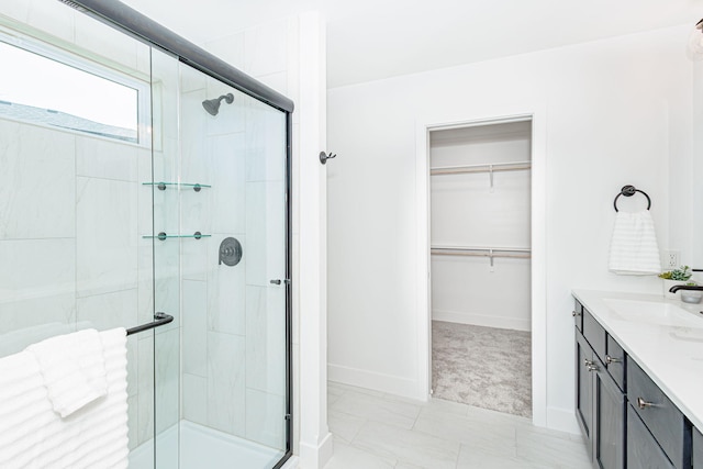 4505 Chambers Bay Dr, Columbia, MO 65201 - full bath featuring a stall shower, vanity, a walk in closet, and baseboards