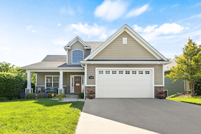 128 Cedar Falls Ct, Columbia, MO 65203 - craftsman-style home with concrete driveway, a front yard, covered porch, and stone siding