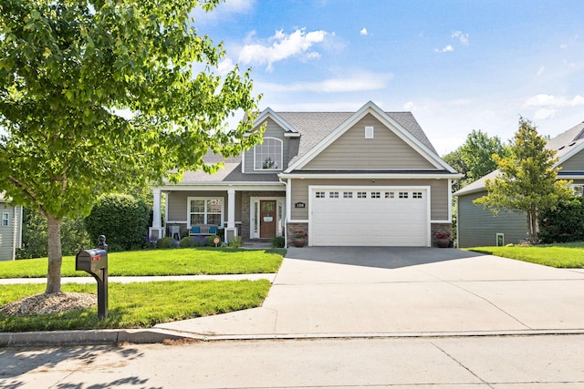 128 Cedar Falls Ct, Columbia, MO 65203 - view of front facade featuring an attached garage, a front lawn, driveway, a porch, and roof with shingles