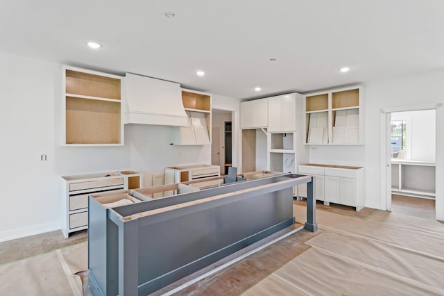 7200 Rudchester Ct, Columbia, MO 65203 - kitchen featuring a center island, open shelves, white cabinets, recessed lighting, and baseboards