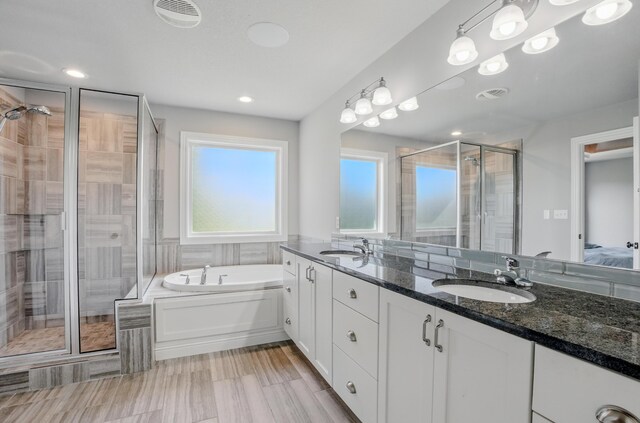 602 E Old Hawthorne Dr, Columbia, MO 65201 - bathroom featuring a shower stall, double vanity, a bath, and recessed lighting