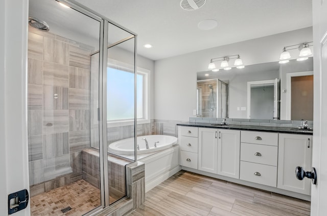 602 E Old Hawthorne Dr, Columbia, MO 65201 - full bathroom featuring a stall shower, double vanity, and a garden tub