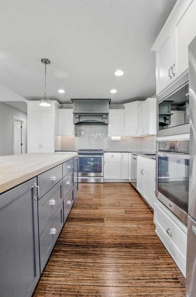 602 E Old Hawthorne Dr, Columbia, MO 65201 - kitchen with appliances with stainless steel finishes, gray cabinetry, premium range hood, white cabinets, and recessed lighting