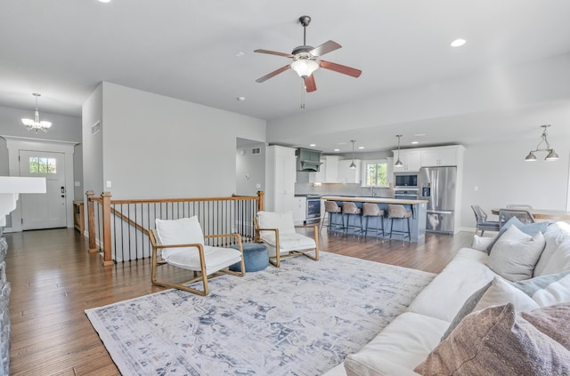 602 E Old Hawthorne Dr, Columbia, MO 65201 - living room featuring a ceiling fan, dark wood-style floors, plenty of natural light, a chandelier, and recessed lighting
