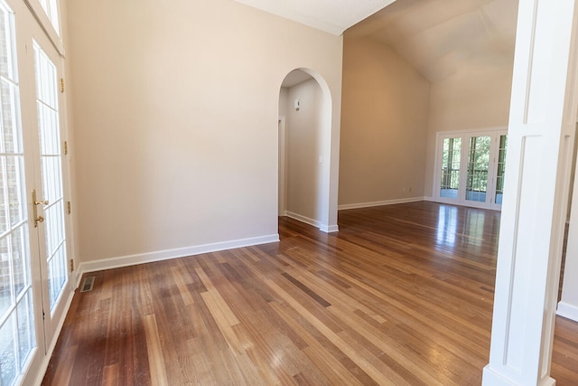 2409 Wild Oak Ct, Columbia, MO 65201 - spare room with arched walkways, wood finished floors, french doors, and lofted ceiling