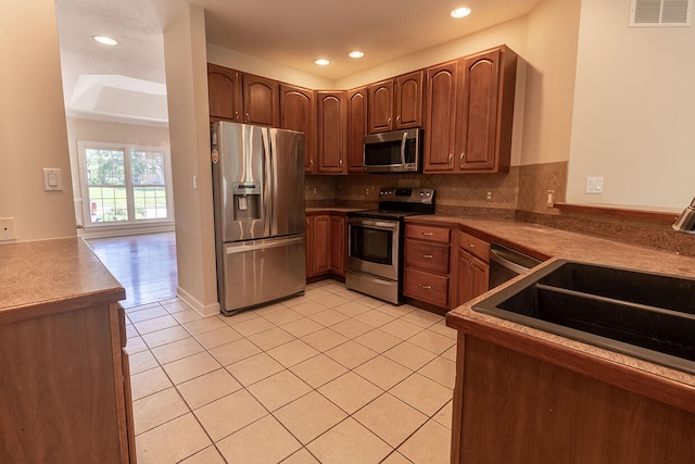 2409 Wild Oak Ct, Columbia, MO 65201 - kitchen featuring stainless steel appliances, light tile patterned floors, backsplash, and recessed lighting